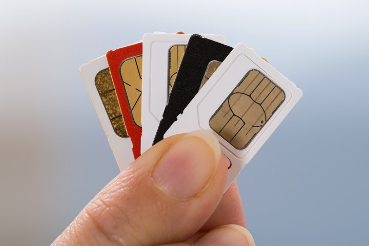 Persönlich hält fünf aufgefächerte SIM-Karten in der Hand.