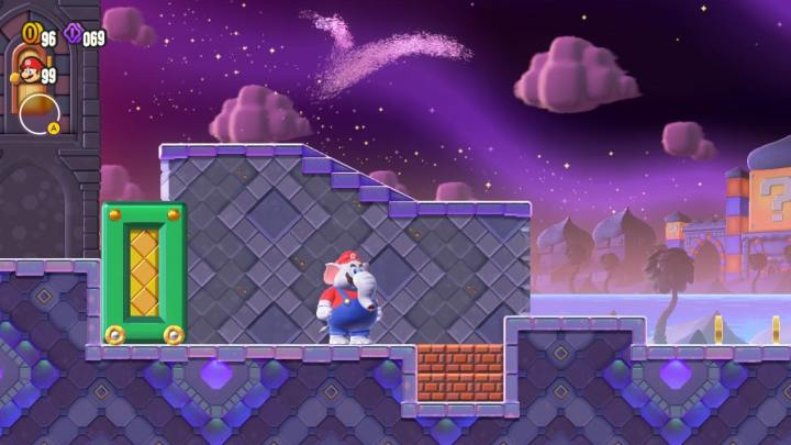 Elefant Mario steht in Super Mario Bros. Wonder in der Nähe einiger Blöcke.