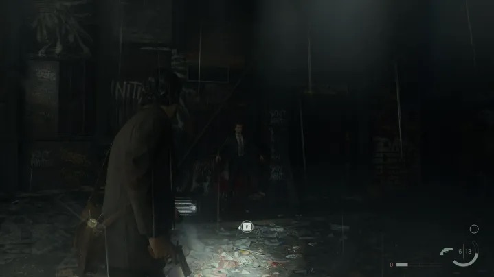Ein Screenshot von Alan Wake 2, der eine dunkle Umgebung zeigt.